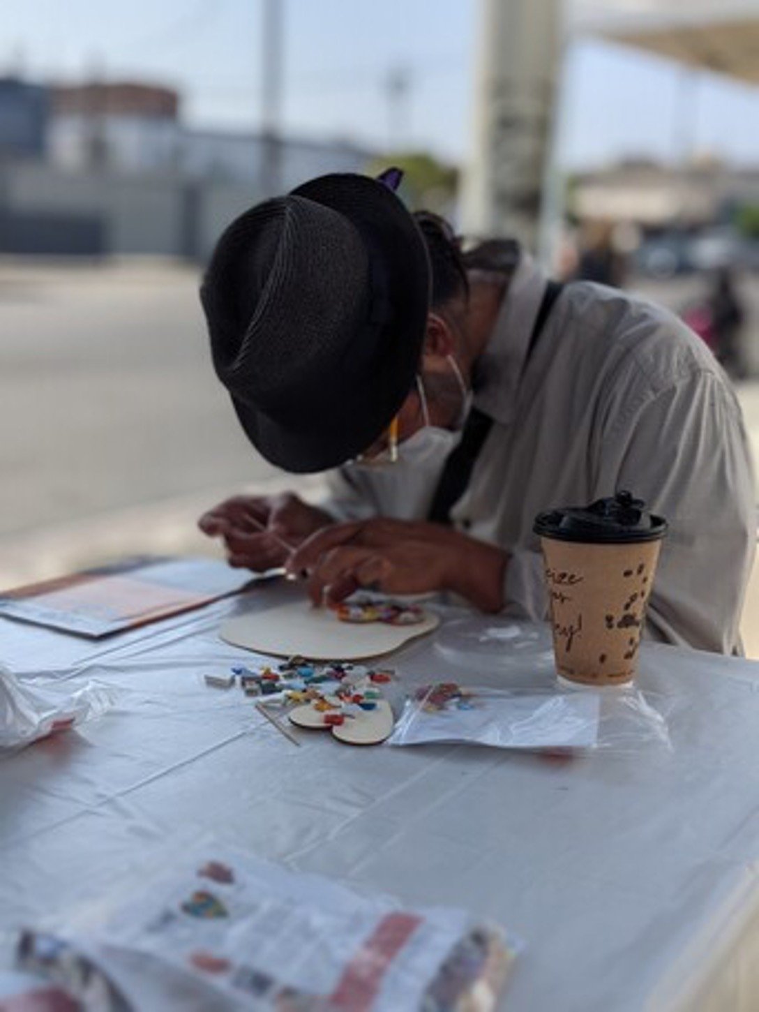 Artist working on a mosaic at a Piece by Piece workshop.